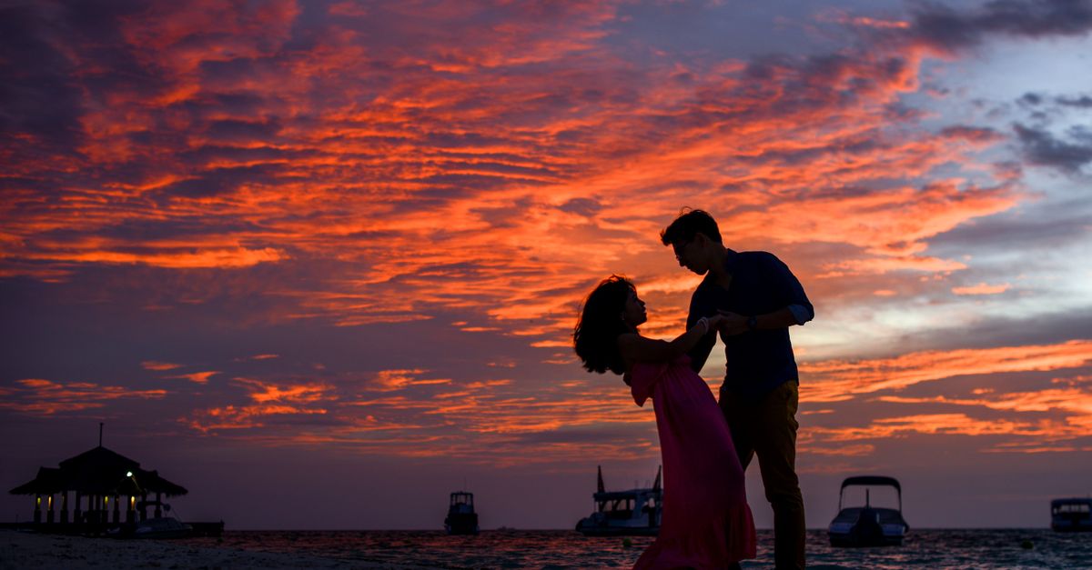 Couple at a beach sunset, Andaman honeymoon package including Neil Island
